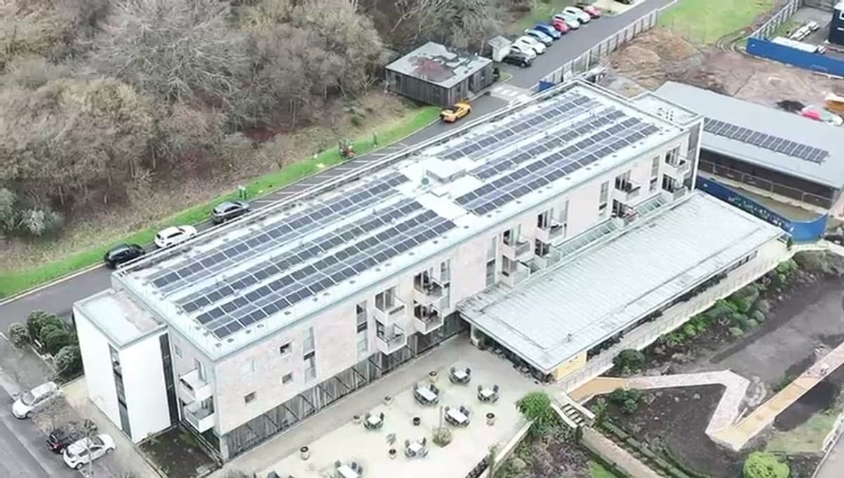 Drone view of a Djuka commercial solar install on a large flat-roof building