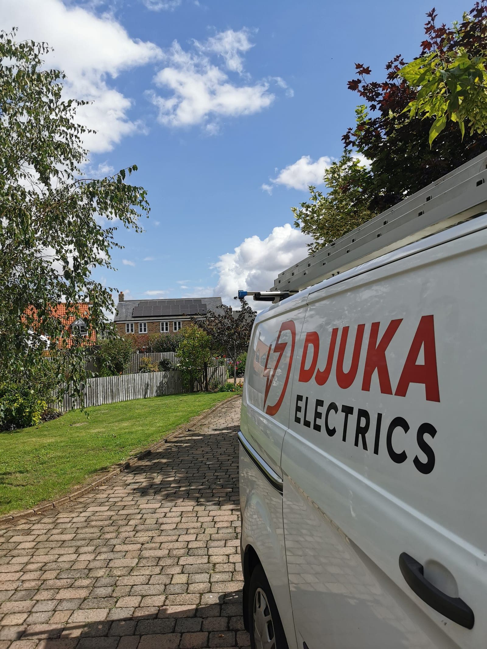 A Djuka Electrics van in a customer's driveway, survey day arrival
